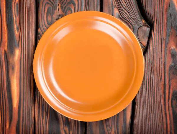 Plate on a wooden table — Stock Photo, Image