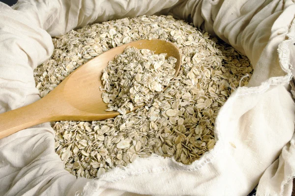 Rolled oats seed in spoon — Stock Photo, Image