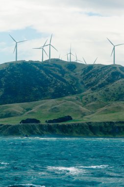 Windfarm wind turbines in mountain terrain clipart