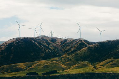 Wind turbines in mountainous terrain clipart