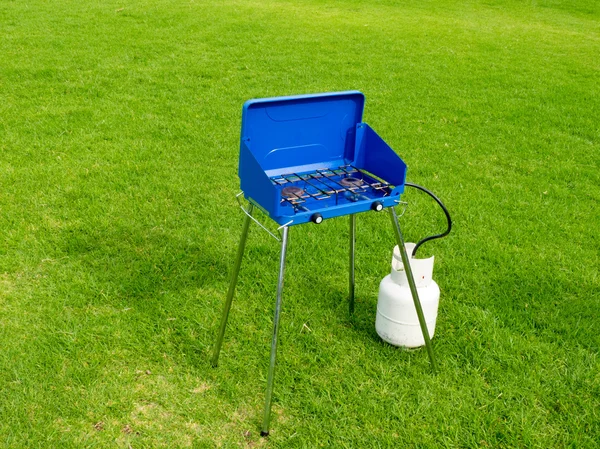 stock image Small two flame gas cook stove on green lawn