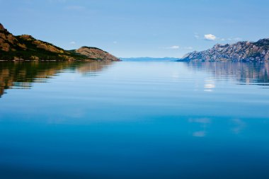 Calm summer day on huge Lake Laberge Yukon Canada clipart