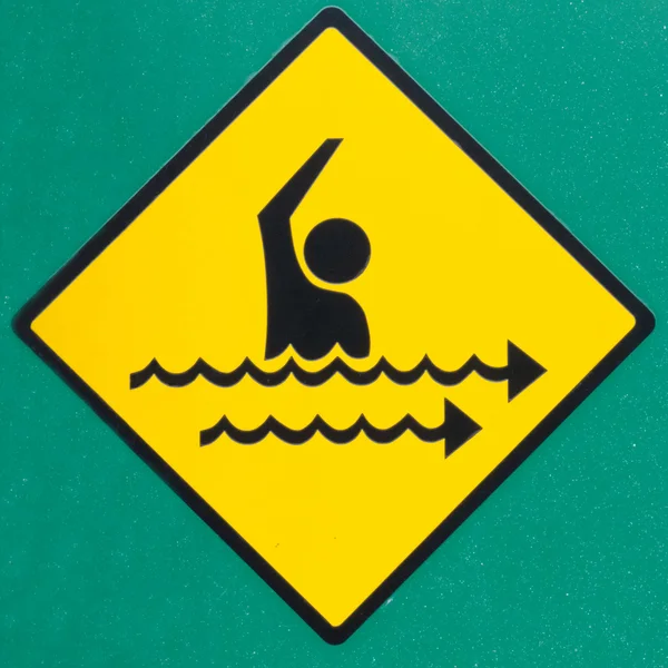 Rip current hazard symbol warning sign on green — Stock Photo, Image