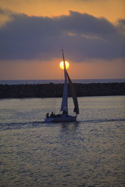 Sailboat at sunset in redondo beach clipart