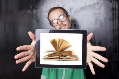 Good Looking Smart Nerd Man With Tablet Computer and book on scr clipart