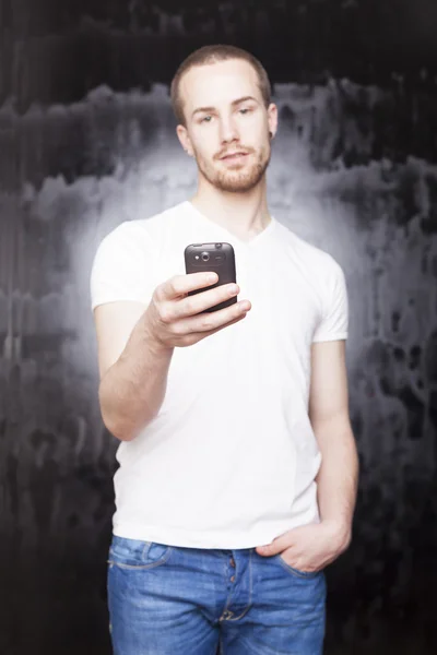 Smartphone in hands of man in white shirt — Stock Photo, Image