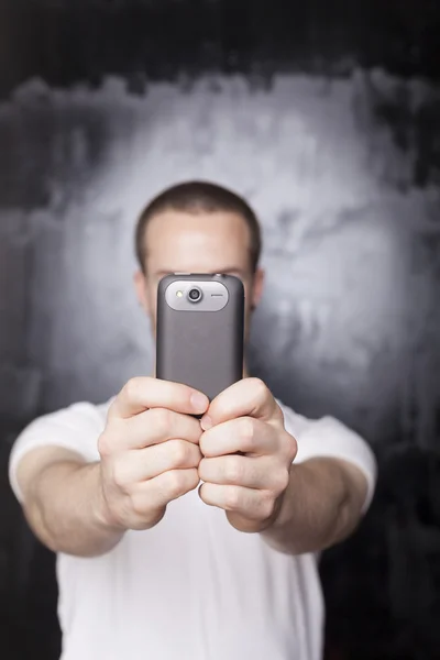 Young man texting with cell phone - smartphone — Stock Photo, Image