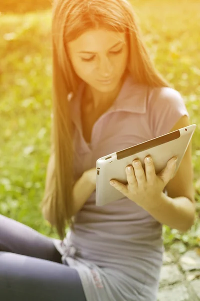 Mulher bonita com computador tablet no parque — Fotografia de Stock