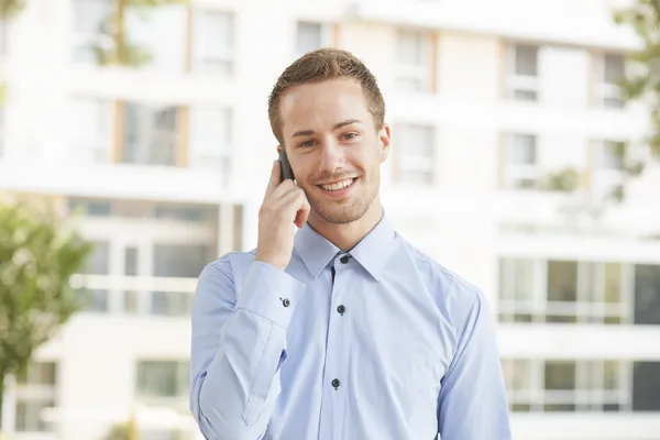 Улыбающийся мужчина разговаривает по телефону — стоковое фото