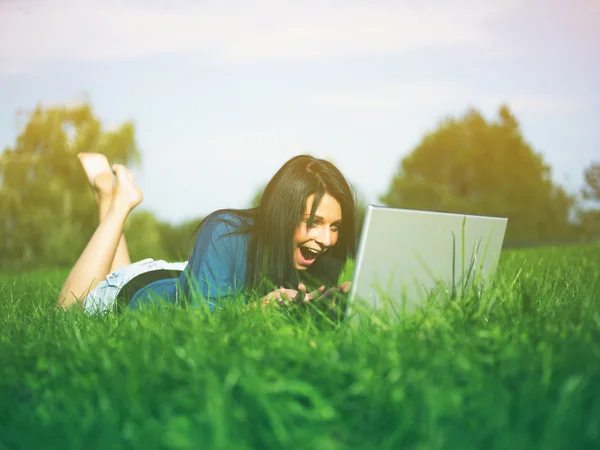 Jeune fille utilisant un ordinateur portable dans le parc — Photo