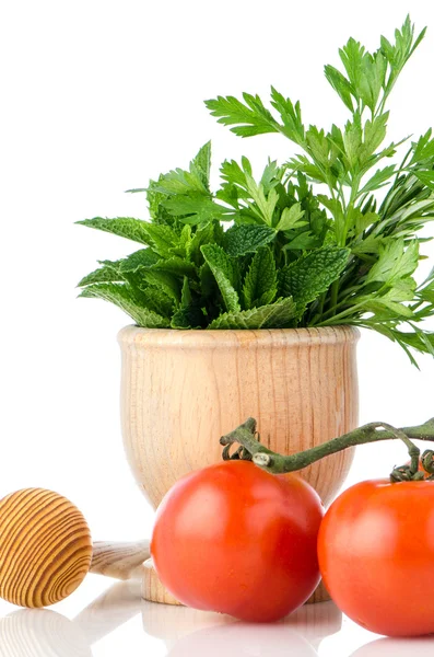 Tomatoes and green herb leafs — Stock Photo, Image