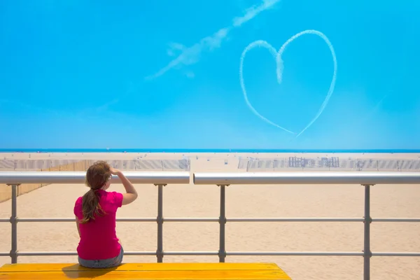 Heart in sky and girl — Stock Photo, Image