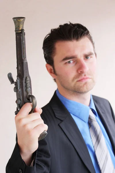 Businessman with a handgun — Stock Photo, Image