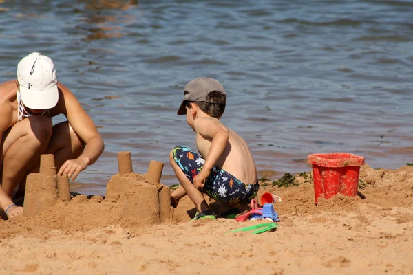 stock image Mother and child building sand castle