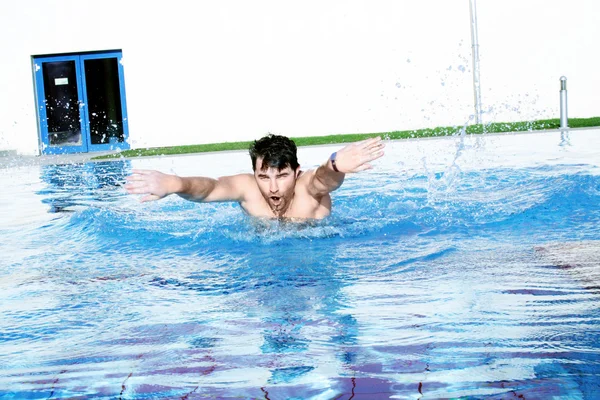Dynamic swimmer in swimming pool — Stock Photo, Image
