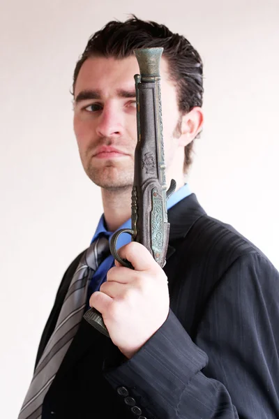 Businessman with ancient weapon — Stock Photo, Image