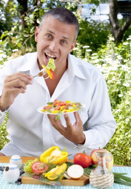 The man the vegetarian tastes salad clipart