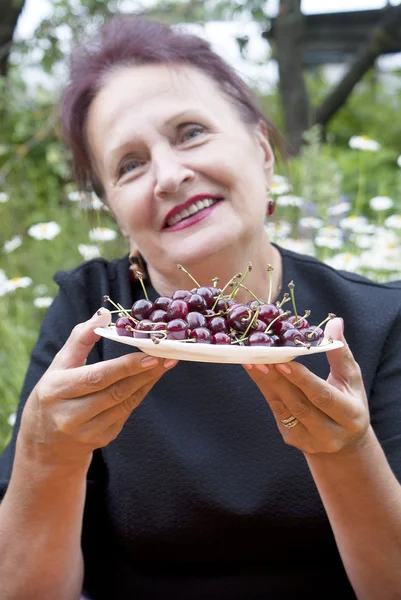The happy smiling woman and cherry — Stock Photo, Image