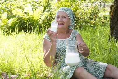 Seniors female drinks fresh milk