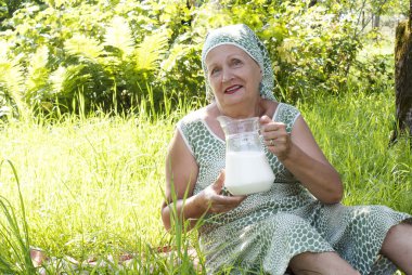 The seniors female with jug fresh milk clipart