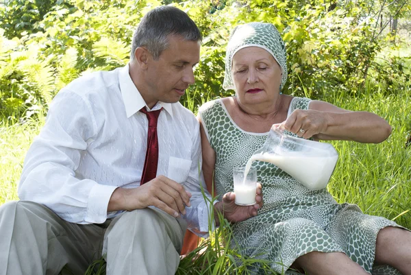 stock image The happy family drinks fresh cow milk