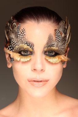 Woman wearing creative feather make-up clipart