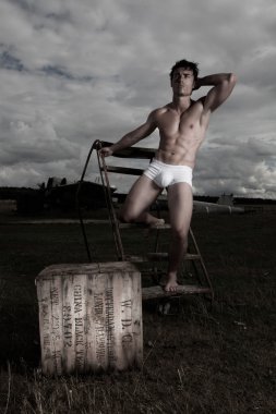 Muscular man posing in briefs clipart