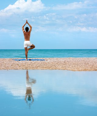 Man Doing Yoga. Vrikshasana Pose (The Tree) clipart