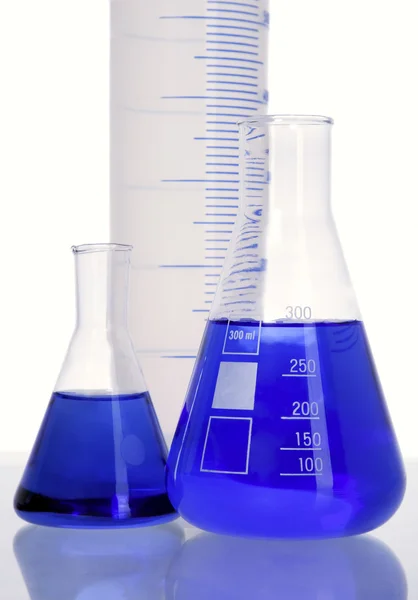 Three flasks with blue fluid — Stock Photo, Image