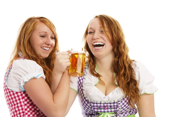 Two bavarian girls cheering with beer — Stock Photo, Image