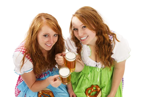 Two bavarian girls with beer and pretzels — Stock Photo, Image