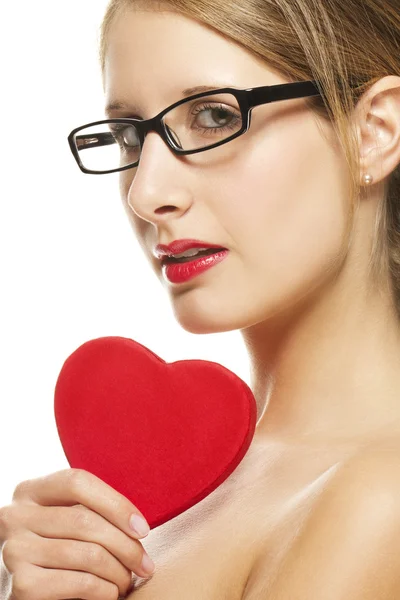Beautiful woman with glasses holding red heart — Stock Photo, Image