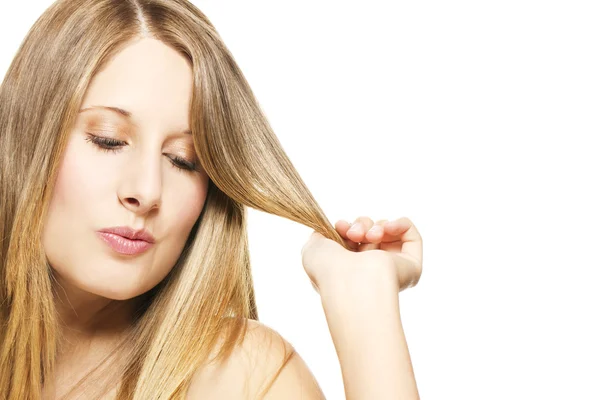 Impishly blonde woman playing with her hairs — Stock Photo, Image