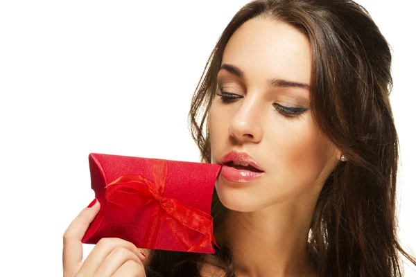 Beautiful woman looking at the present near her face — Stock Photo, Image