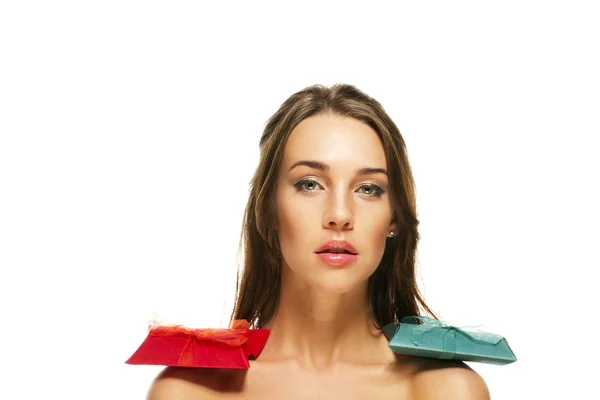 Beautiful woman with red and green presents on her shoulders — Stock Photo, Image