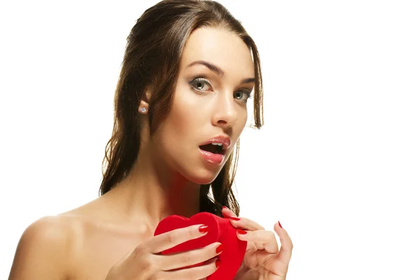 Beautiful woman about to open a red heart shaped box — Stock Photo, Image