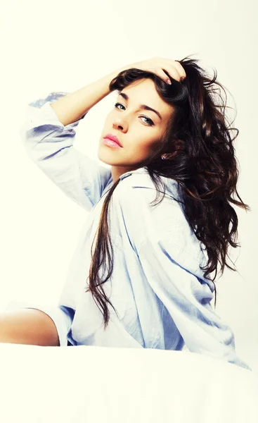 stock image Brunette woman in bed holding her hair