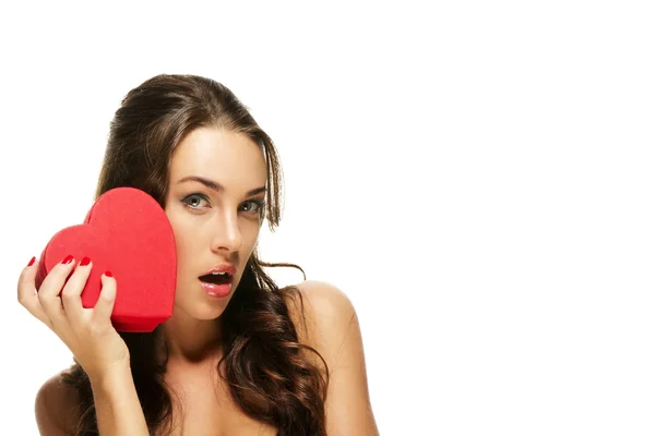 Beautiful surprised woman with a red heart — Stock Photo, Image