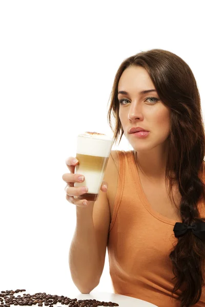 Beautiful woman with latte macchiato coffee bites on her lips — Stock Photo, Image