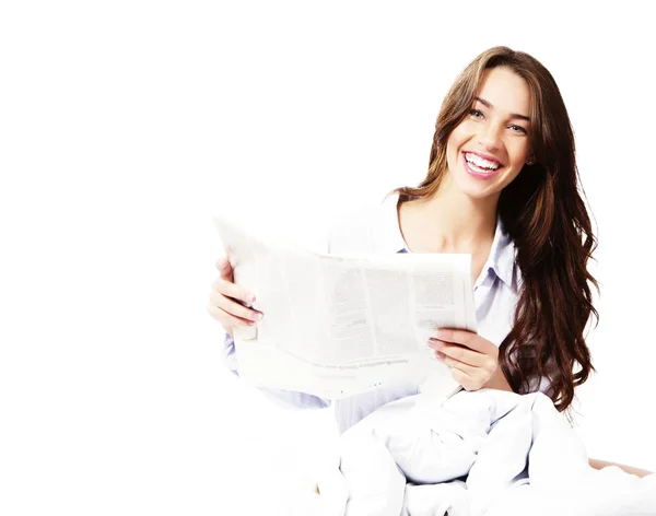 Bir gazete ile yatakta mutlu bir kadın — Stok fotoğraf
