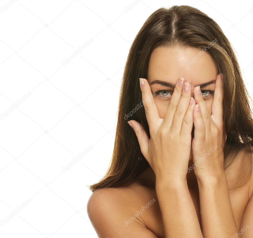 Beautiful woman covering her face with her hands Stock Photo by