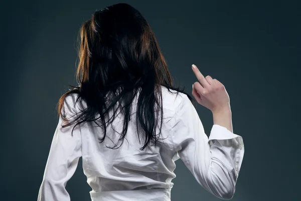 Young woman from back showing the finger — Stock Photo, Image