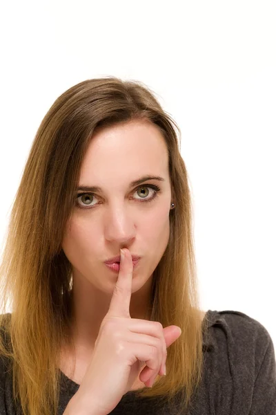 Donna tenendo un dito alla bocca per zittire — Foto Stock