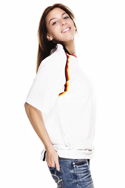 Happy beautiful woman wearing football shirt with hand in her back pocket — Stock Photo, Image