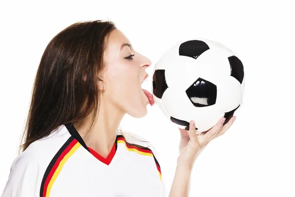 Beautiful woman wearing football shirt licking on a football — Stock Photo, Image