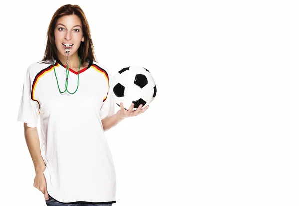 Beautiful woman with a whistle wearing football shirt and holding football — Stock Photo, Image
