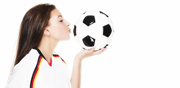 Beautiful young woman kissing a football — Stock Photo, Image