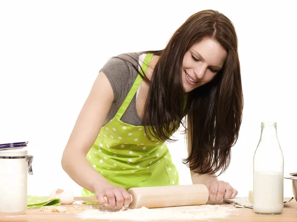 Young woman using rolling pin on dough — Stock Photo, Image