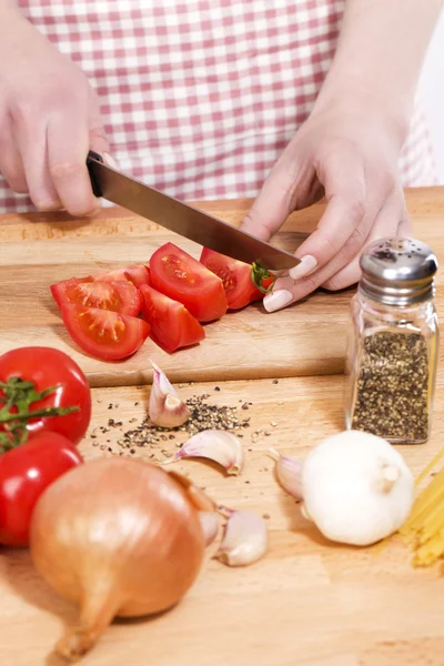 stock image Closeup of hands cutting tomatoes