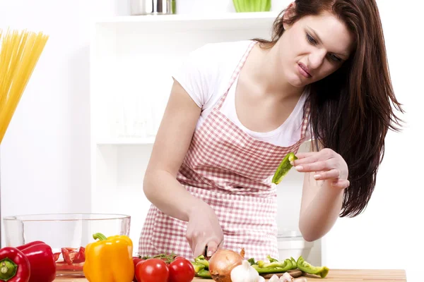 Young woman is suspicious about the vegetable — Stock Photo, Image